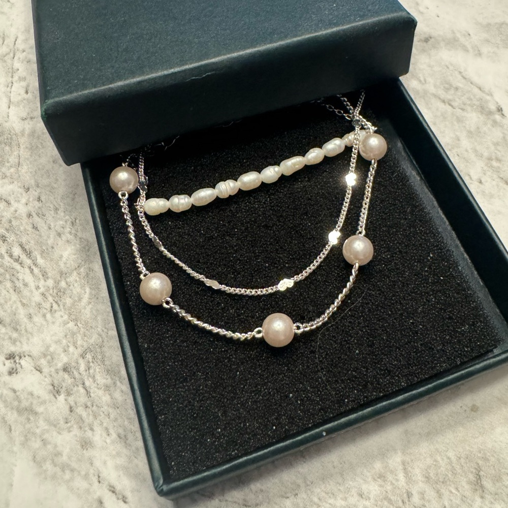 Set of three silver and pearl bracelets